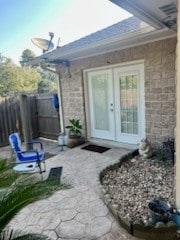 property entrance with a patio area and french doors