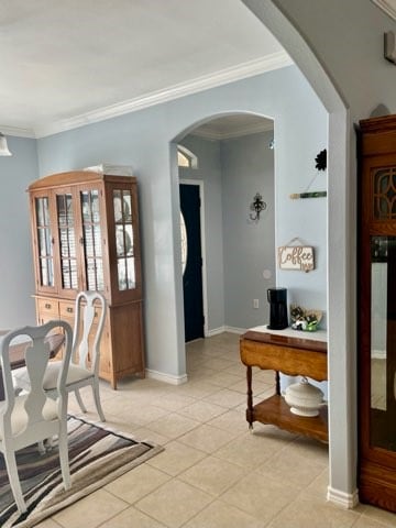 dining area featuring light tile patterned floors and ornamental molding