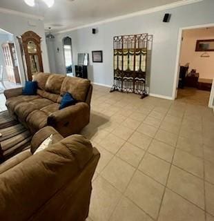 861 Redwood Ave, Rockport, TX 78382 - living room featuring crown molding, light tile patterned floors, a ceiling fan, and baseboards