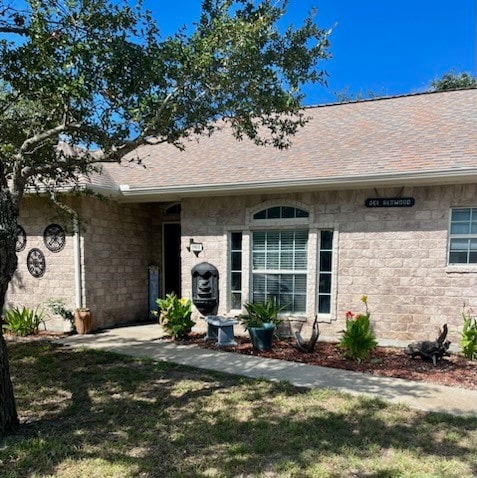 entrance to property featuring a yard