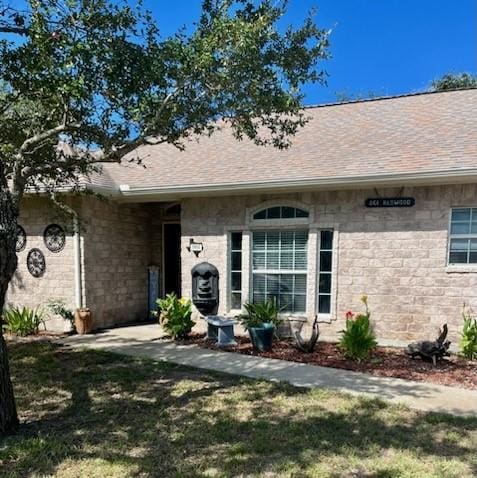 861 Redwood Ave, Rockport, TX 78382 - entrance to property with a shingled roof and a yard