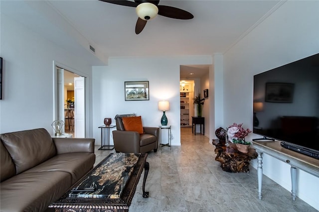 living room featuring ornamental molding, visible vents, and a ceiling fan