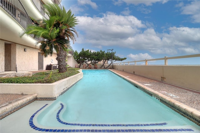 view of swimming pool with a fenced backyard and a fenced in pool