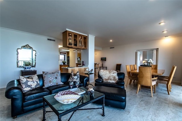 living room featuring baseboards, visible vents, and recessed lighting