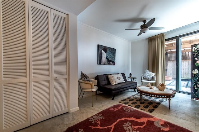 sitting room featuring ornamental molding, plenty of natural light, baseboards, and ceiling fan