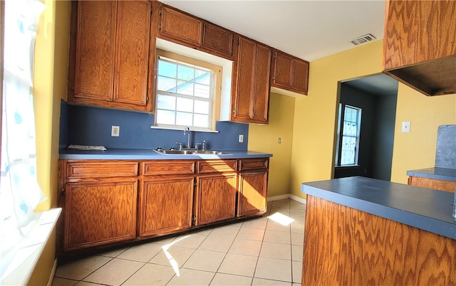 kitchen featuring light tile patterned flooring and sink