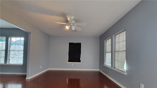 unfurnished room with dark wood-type flooring and ceiling fan