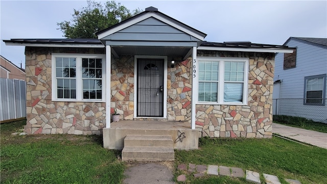 bungalow-style house with a front lawn