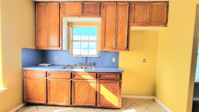 kitchen with light tile patterned flooring and sink