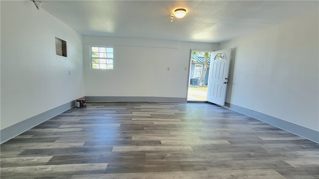 unfurnished room with dark hardwood / wood-style flooring