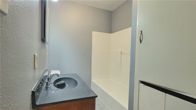 bathroom with vanity and a shower