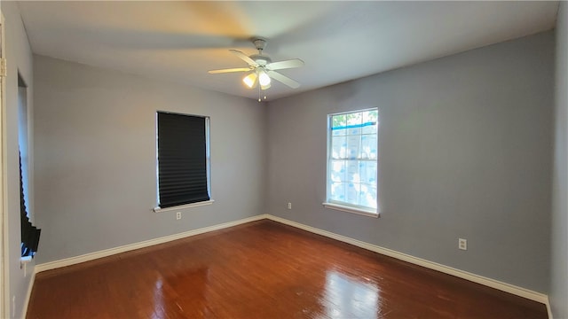 empty room featuring dark hardwood / wood-style floors and ceiling fan