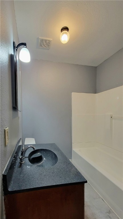 bathroom with vanity and bathing tub / shower combination