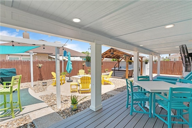 15209 Dasmarinas Dr, Corpus Christi, TX 78418 - wooden deck with a hot tub, a fenced backyard, outdoor dining space, and a patio area