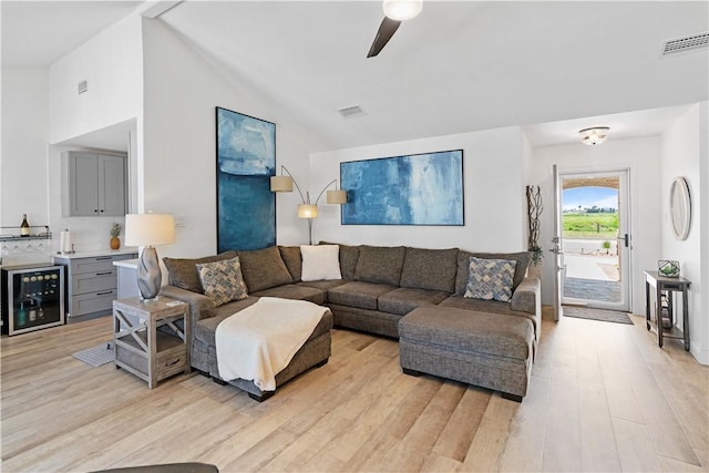 15209 Dasmarinas Dr, Corpus Christi, TX 78418 - living area with light wood-style floors, wine cooler, ceiling fan, and vaulted ceiling