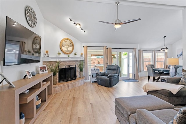 15209 Dasmarinas Dr, Corpus Christi, TX 78418 - living room with wood finished floors, a brick fireplace, a ceiling fan, plenty of natural light, and high vaulted ceiling