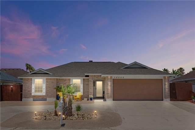 15209 Dasmarinas Dr, Corpus Christi, TX 78418 - single story home featuring concrete driveway, a garage, a shingled roof, and brick siding