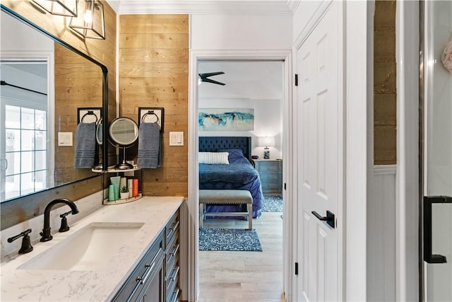 15209 Dasmarinas Dr, Corpus Christi, TX 78418 - ensuite bathroom featuring ornamental molding, vanity, wood finished floors, and wooden walls