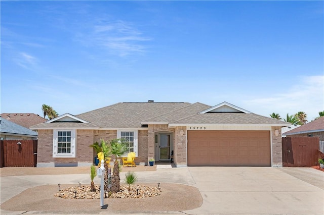 15209 Dasmarinas Dr, Corpus Christi, TX 78418 - ranch-style house with driveway, a garage, brick siding, and a shingled roof