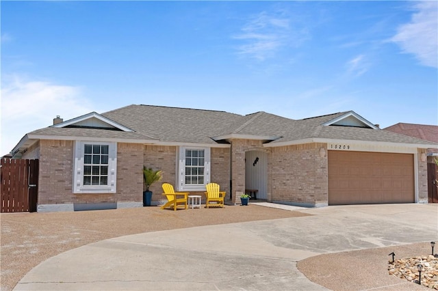 15209 Dasmarinas Dr, Corpus Christi, TX 78418 - ranch-style house with brick siding, driveway, an attached garage, and a shingled roof