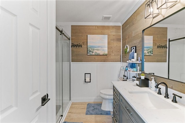15209 Dasmarinas Dr, Corpus Christi, TX 78418 - bathroom with vanity, a shower stall, ornamental molding, wood walls, and wood finished floors
