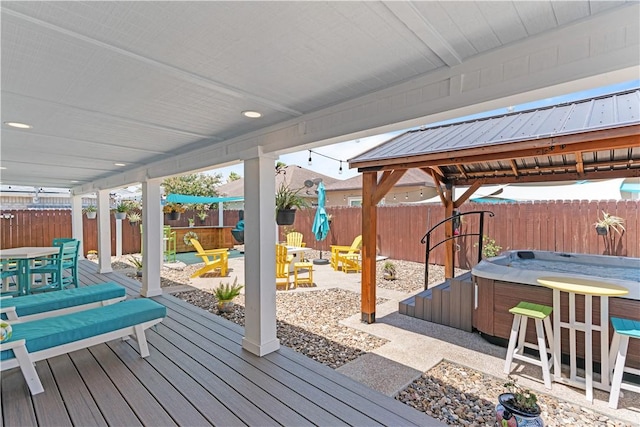 15209 Dasmarinas Dr, Corpus Christi, TX 78418 - wooden deck with a hot tub, a fenced backyard, outdoor dining area, and a gazebo