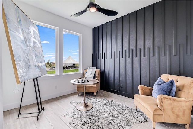 sitting room with a wealth of natural light, ceiling fan, and light hardwood / wood-style flooring