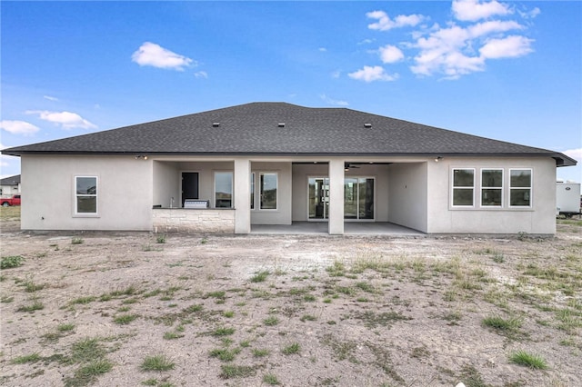 back of property with a patio