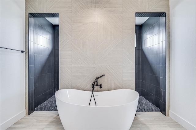 bathroom with tile walls and independent shower and bath