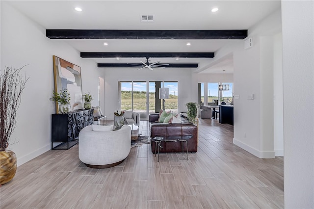 living room with ceiling fan with notable chandelier, beam ceiling, and light wood-type flooring