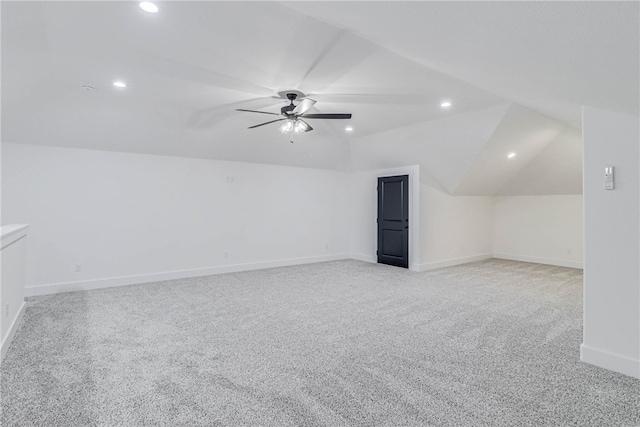 additional living space featuring light colored carpet, lofted ceiling, and ceiling fan