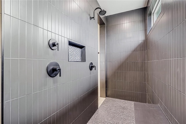 bathroom with tiled shower