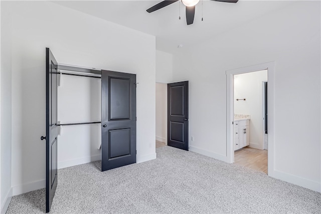 unfurnished bedroom featuring ensuite bathroom, ceiling fan, and light carpet