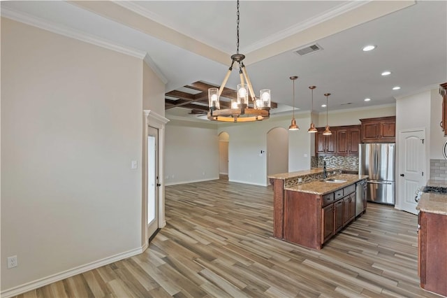 6913 Mets Ct, Corpus Christi, TX 78414 - kitchen featuring appliances with stainless steel finishes, arched walkways, backsplash, a chandelier, and recessed lighting