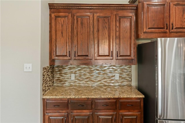 6913 Mets Ct, Corpus Christi, TX 78414 - kitchen with freestanding refrigerator, backsplash, and light stone counters