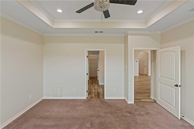 6913 Mets Ct, Corpus Christi, TX 78414 - unfurnished bedroom featuring a tray ceiling, ornamental molding, carpet flooring, arched walkways, and recessed lighting