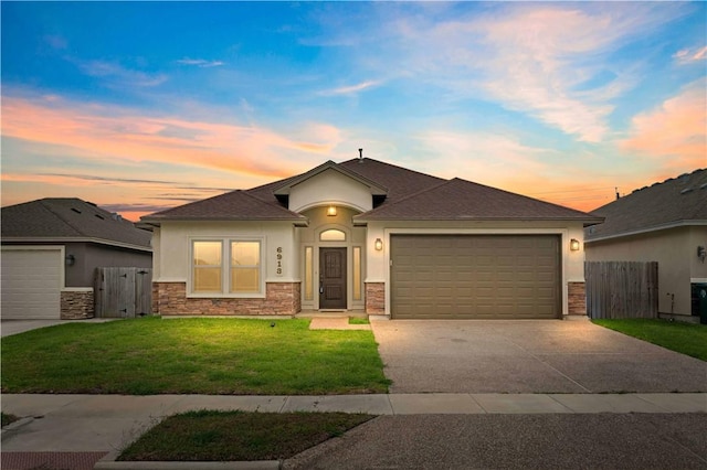 6913 Mets Ct, Corpus Christi, TX 78414 - view of front facade with stucco siding, an attached garage, concrete driveway, and stone siding