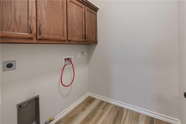 6913 Mets Ct, Corpus Christi, TX 78414 - washroom with hookup for a gas dryer, cabinet space, washer hookup, wood finished floors, and baseboards