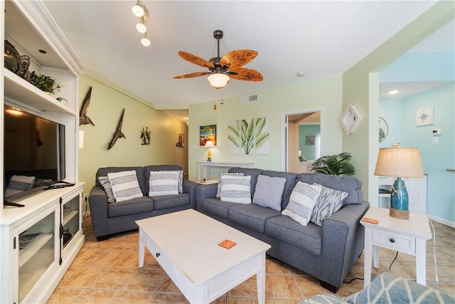 living area featuring ceiling fan, light tile patterned flooring, and visible vents