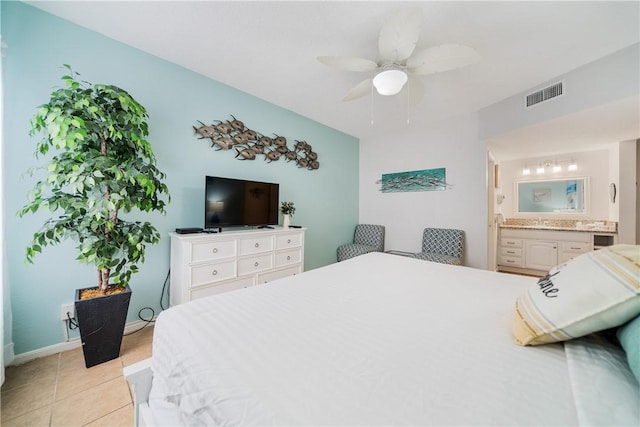 bedroom featuring light tile patterned floors, connected bathroom, a ceiling fan, visible vents, and baseboards