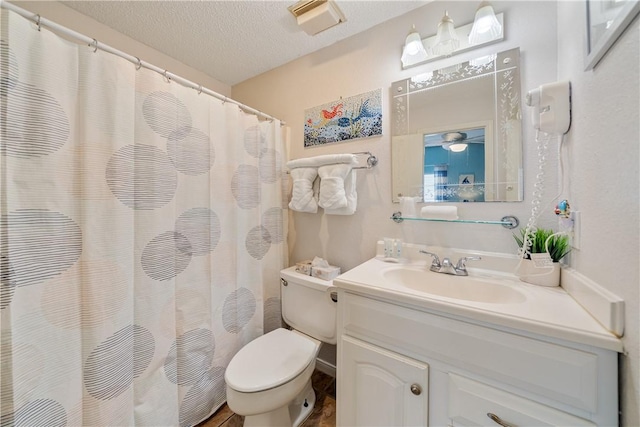 full bathroom with visible vents, a shower with shower curtain, toilet, a textured ceiling, and vanity