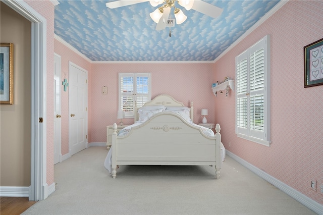 bedroom featuring light colored carpet, ceiling fan, and crown molding