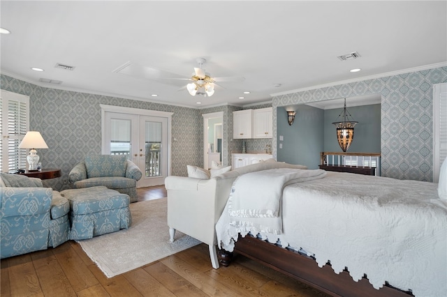 bedroom featuring french doors, crown molding, access to exterior, hardwood / wood-style flooring, and ceiling fan with notable chandelier