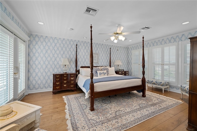 bedroom featuring access to exterior, light hardwood / wood-style flooring, ceiling fan, and crown molding