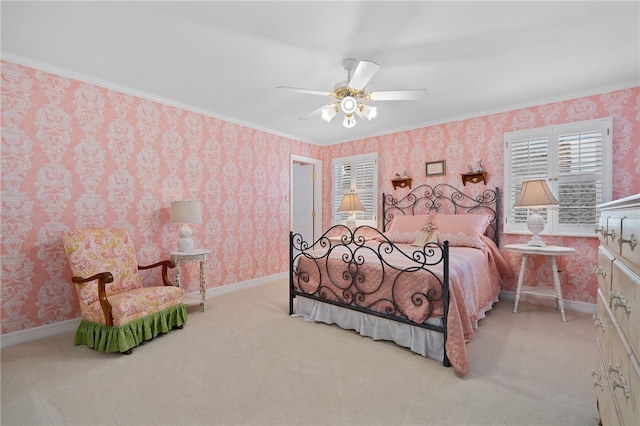 bedroom with light colored carpet, ceiling fan, and crown molding