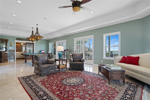 living room featuring pool table, ceiling fan with notable chandelier, and crown molding