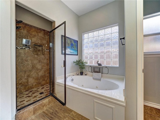 bathroom with separate shower and tub and tile patterned floors