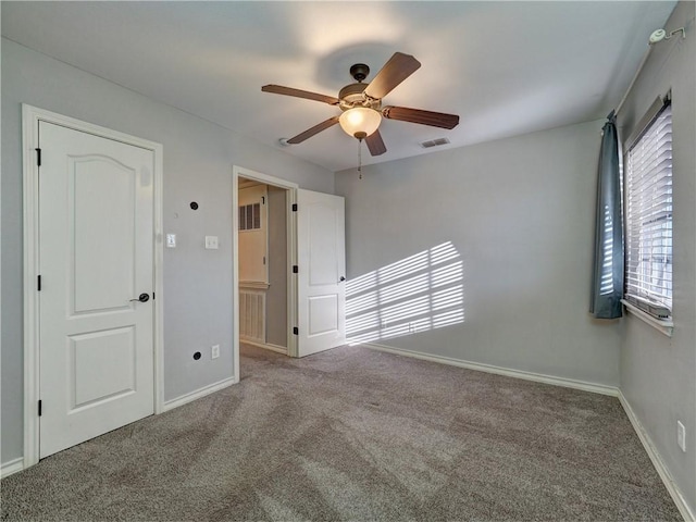 carpeted empty room with ceiling fan