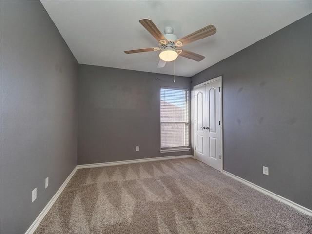 unfurnished room with light colored carpet and ceiling fan