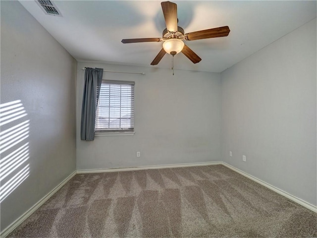 carpeted spare room featuring ceiling fan